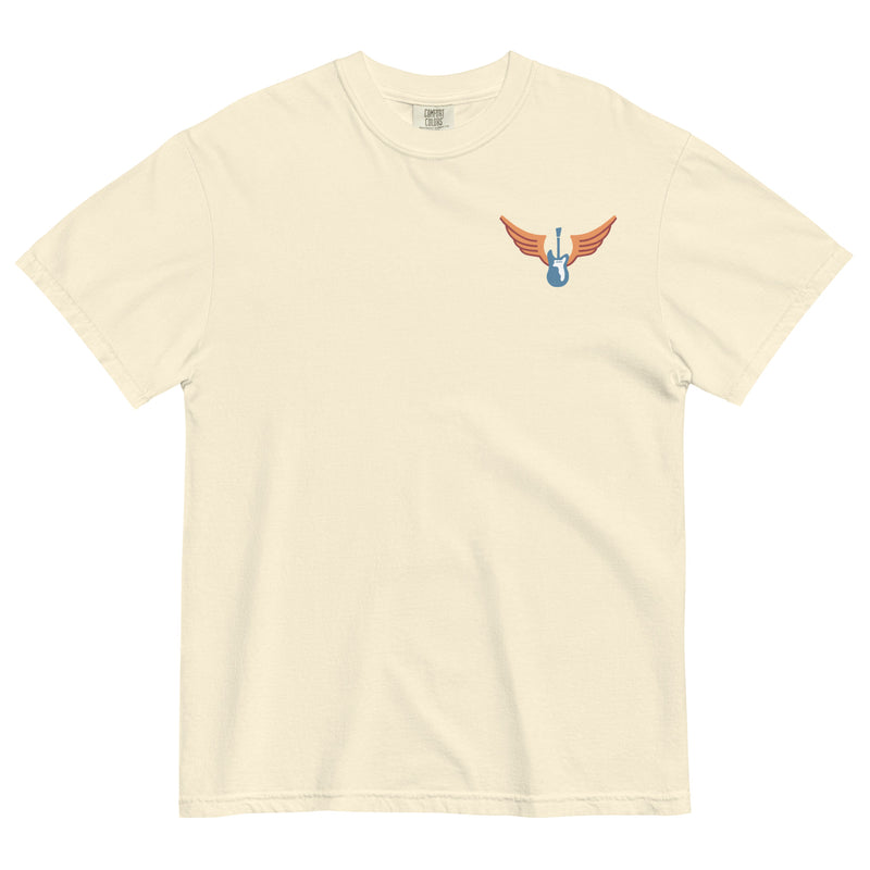 Cream colored Comfort Colors shirt with vintage-style text that reads 'Richard Valenzuela and his Flying Guitar' with an image of a blue guitar and orange wings from Sew Bonita in Corpus Christi, Texas